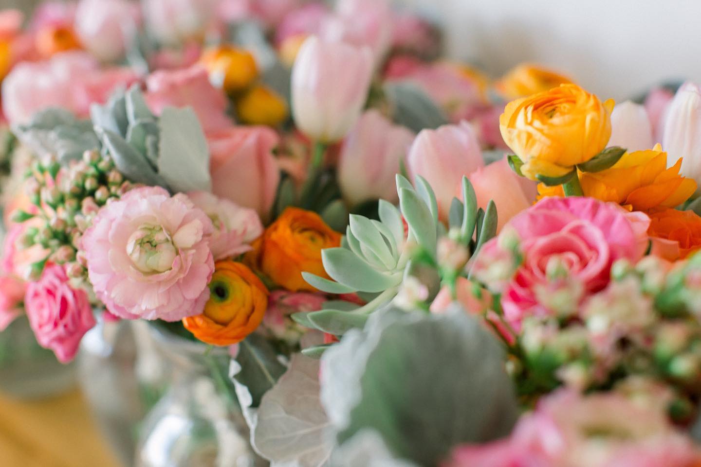 pink and orange flower arrangements with succulents