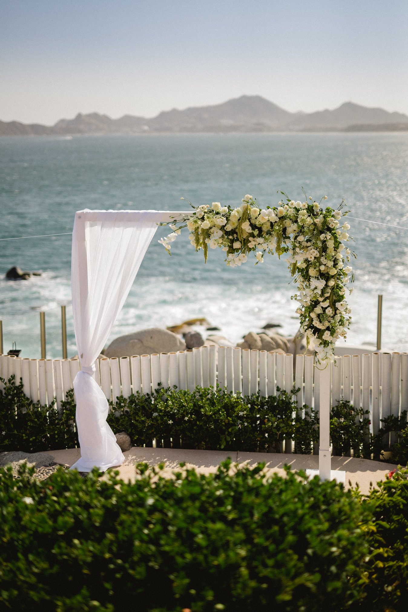 white wedding arch on the beach