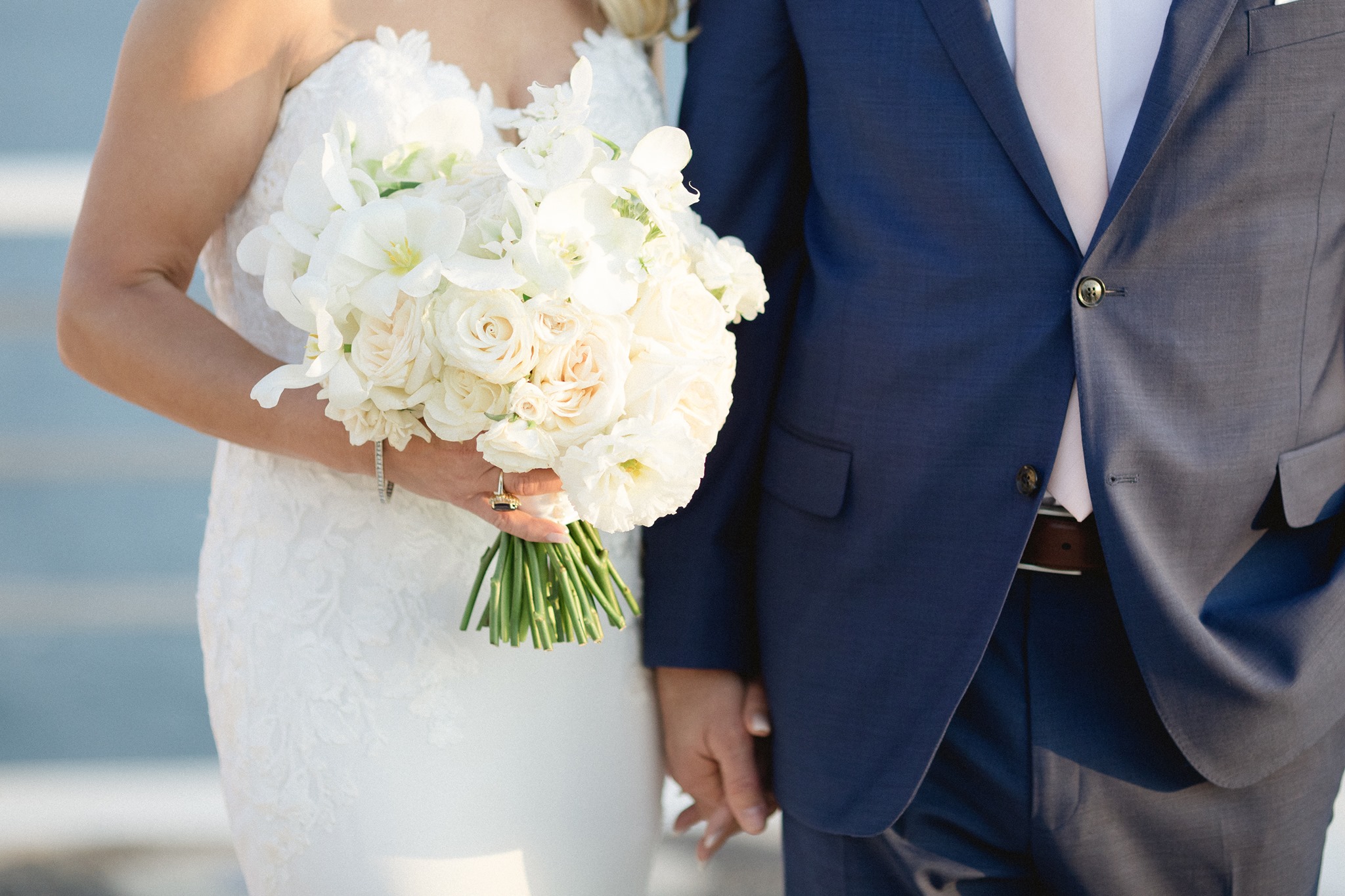white bridal bouquet with roses and plumeria