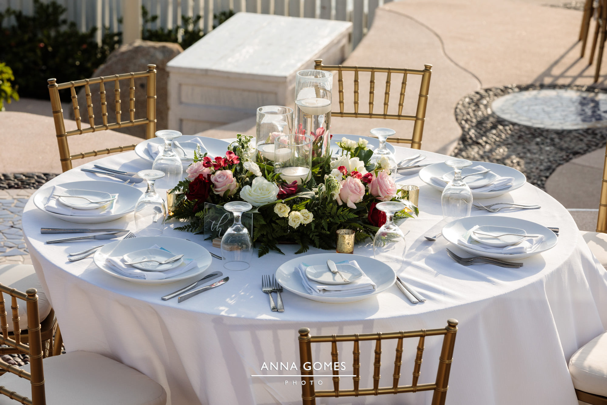 wedding reception table with large floral centerpiece surrounding candles